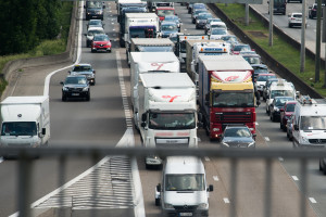 Busses, commercial vehicles, vans and lorries driving on a motorway